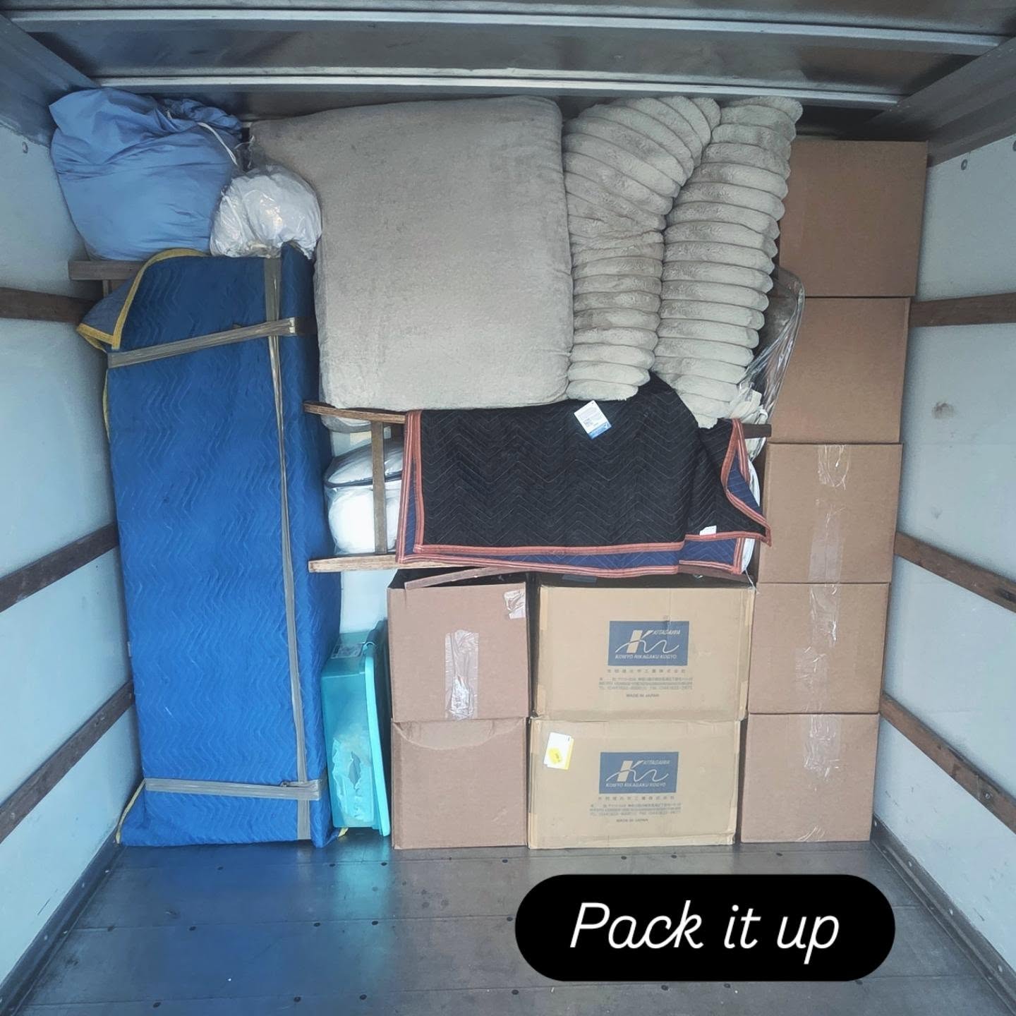 Truck packed with furniture and boxes