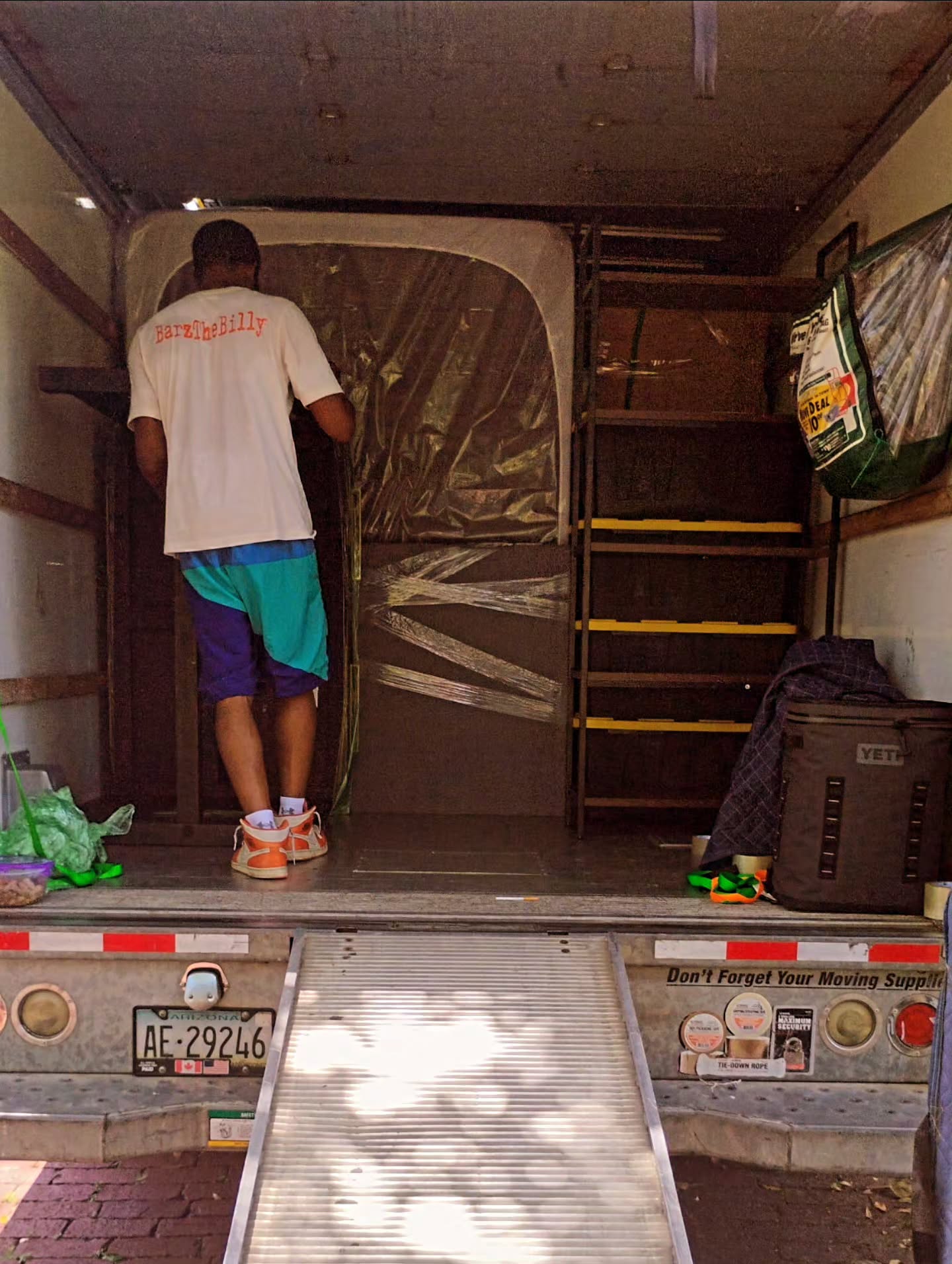 Mover loading furniture into the Perfect Touch Moving truck